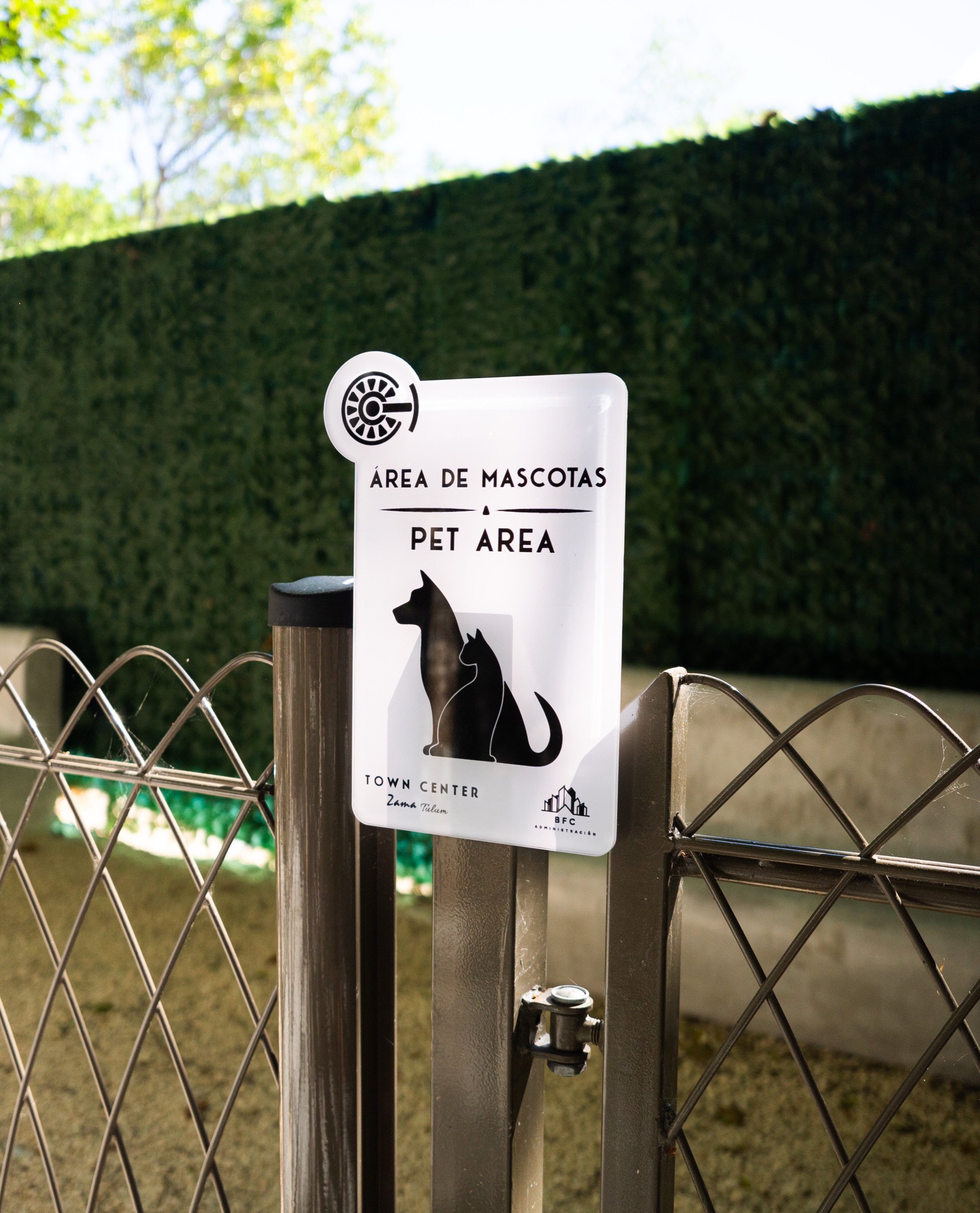 Fenced pet area with its own signage inside the complex