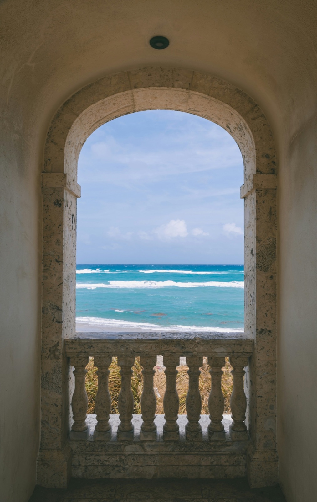 Stone arch balcony over the Caribbean sea